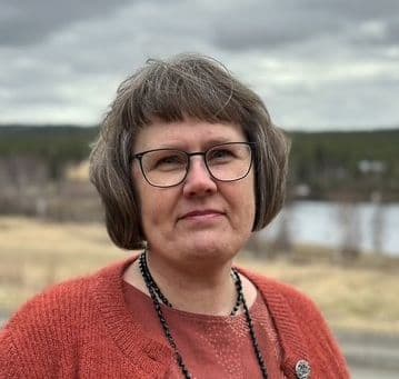 Leende kvinna i röd tröja.